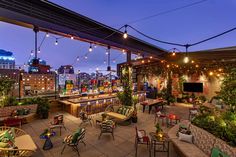 an outdoor patio with lots of seating and lights