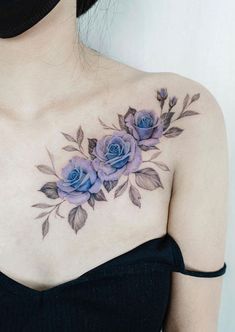 a woman's chest with blue roses on it