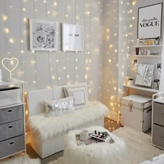 a room with white furniture and lights on the walls