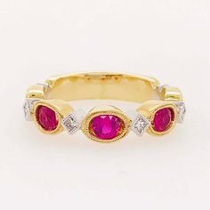 This "Ruby Romance" ring is gorgeous!! The rubies are round, faceted gemstones that are set in oval, milgrain bezels. The oval settings give the rubies an elongated look that's innovative and alluring! Set in between each ruby is a square-cut or princess cut, white diamond! The diamonds are natural diamonds that are bright white and very clean! The diamonds are set, on point, in white gold, square bezels with matching milgrain beading framing each stone. We currently have this ring with rose gol Classic Oval Lab-created Ruby Diamond Ring, Oval Red Ruby Ring With Three Stones, Luxury Oval Three-stone Ruby Ring, Oval Ruby Ring With Rose Cut Diamonds, Oval Ruby Ring With Three Diamonds, Oval Three Stone Ruby Ring With Diamonds, Oval Diamond Ring With Lab-created Ruby Accents, Oval Lab-created Ruby Rings With Rose Cut Diamonds, Luxury Oval Rings With Rose Cut Diamonds And Ruby