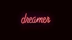 a red neon sign that says,'dream'in the middle of black background