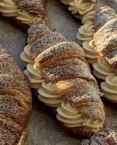 some very tasty looking pastries with icing on them and powdered sugar