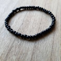 This bracelet is made up of glass seed beads in an opaque black color. Perfect for stacking together, wearing alone, or pairing with a chunky bracelet. The options are endless! (Bracelet sold individually). Great as gifts! Size shown: 7 inches Strung on pre-stretched bracelet material. SIZINGThe sizing chart is the standard for stretch bracelets. Since material is pre-stretched there is some leeway or give as far as how the bracelet fits on your wrist. TIP FOR MEASURING: Best rule of thumb when Rule Of Thumb, Chunky Bracelet, Seed Bead Bracelet, Chunky Bracelets, Black Seed, Seed Bead Bracelets, Glass Seed Beads, Black Glass, Bead Bracelet