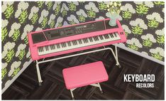 a pink piano sitting on top of a hard wood floor next to a vase with flowers