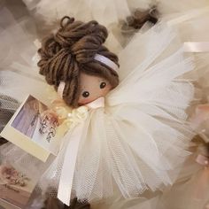 there is a small doll that is wearing a white dress