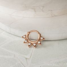 "Geometric with just the right amount of sparkle, this 14k rose gold genuine diamond helix hoop is truly unique and lots of fun to wear.  Materials: * 14k solid rose gold (Weight: 1.45g) * Genuine or lab grown white diamond (Weight: 0.07ct VS-SI/G-H) Measurements:      Inner diameter: 0.3\" - 8mm Outer diameter: 0.7\" - 18mm Wire thickness: 18g - 1mm Number of diamonds: 7 Diamond size: 1.3mm To keep your jewelry looking new, take a soft cloth or toothbrush with mild soap and gently brush/wipe th Hypoallergenic Rose Gold Hoop Septum Ring, Rose Gold Internally Threaded Hoop Septum Ring, Small Hoop Rose Gold Jewelry With Diamond Accents, Rose Gold Diamond Cut Huggie Jewelry, Small Hoop Rose Gold Jewelry With Prong Setting, Rose Gold 14k Hoop Septum Ring, Internally Threaded Rose Gold Septum Ring, Gold Cartilage Earrings, Helix Ring