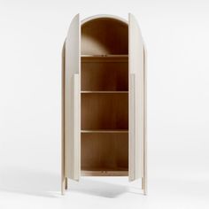 a white cabinet with an arched door and shelves on both sides, in the shape of a bookcase