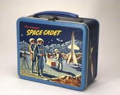 an old tin lunch box with space cadet on the front and two astronauts standing next to it