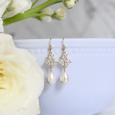 Dainty yet glamorous, The Rose Earrings in Gold, are the perfect accessory to accent a bateau neckline for both you and your bridesmaids. The subtle sparkle adds a touch of elegance to your wedding day look. Size: 1.5" long Materials: cubic zirconia, Swarovski pearls in white Metals: gold filled ear wires and components Find the matching necklace here Elegant Rose Gold Earrings For Wedding, Classic Elegant Crystal Earrings For Wedding, Elegant Gold Bridal Accessories With Cubic Zirconia, Elegant Rose Gold Bridal Earrings For Wedding, Elegant Bridal Accessories For Anniversary, Classic Crystal Earrings For Wedding With Elegant Design, Elegant Rose Gold Bridal Earrings, Elegant Crystal Bridal Accessories For Mother Of The Bride, Elegant Formal Bridal Accessories With Pearl Drop