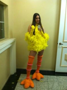 a woman dressed as a chicken holding a cell phone in her hand and wearing bright yellow socks