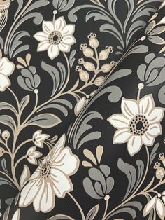 black and white floral wallpaper with gold accents on the bottom half of the image