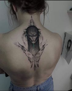 a woman with a tattoo on her back