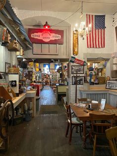 the inside of an old fashioned store with many items on display and signs hanging from the ceiling