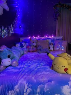 a bed with stuffed animals on it in a room filled with lights and decorations at night