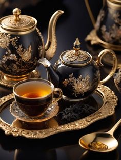 a black tea set with gold trimmings on it