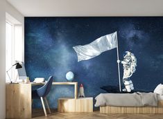 a bedroom with a space themed wall mural