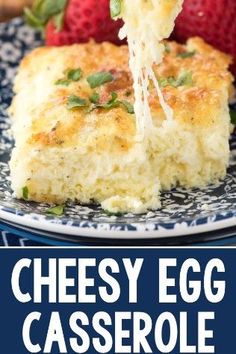 cheesy egg casserole on a blue and white plate with strawberries