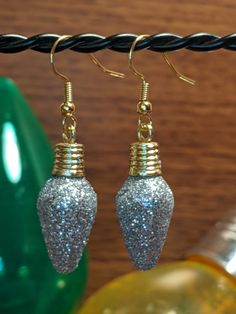 These adorable Christmas earrings will be a perfect addition to your holiday outfits! These light weight Christmas Earrings are perfect for the Holiday Season! Silver Sparkle, Christmas Earrings, Silver Earrings Dangle, Holiday Outfits, The Holiday, Light Bulb, Holiday Season, Dangle Earrings, Sparkle