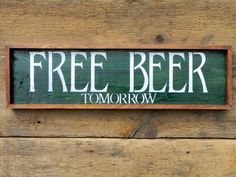 a wooden sign that says free beer tomorrow