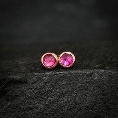 "Tiny Ruby Stud Earrings. Unique Rustic Organic Ruby Stud Earrings. Round Rose Cut Ruby Studs. Pink Gemstone Stud Earring. Valentines Gift This listing is for one pair of tiny Ruby earrings. Pictured earrings are in 14k rose gold. DETAILS:  Stone: natural raw untreated Ruby Size: around 3mm Metal:  - 925 sterling silver or oxidized silver - 14k solid yellow, rose and white gold SHIPPING: - express shipping with expected delivery in 2-8 business days world wide, contact phone number required. HURRY?: Now you can purchase \"rush order\" service to shorten processing time to 3 business days: https://www.etsy.com/listing/511461788/rush-order ..Made with LOVE and PASSION in Estonia.." Rose Gold Ruby Round Earrings, Red Stone Earrings Gold Studs, Nickel-free Ruby Earrings As A Gift, Red Ruby Single Earring, Red Ruby Earrings Studs, Ruby Stud Earrings, Ruby Earrings Studs, Stud Earrings Unique, Electroformed Jewelry