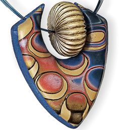 a ceramic ornament with a shell hanging from it's side on a string