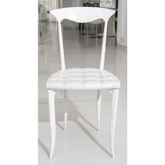 a white chair sitting on top of a tiled floor