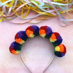 This multi- coloured headband is sure to get you noticed wherever you go! The six woollen pom poms are all the colours of the rainbow; red, orange, yellow, green, blue and purple. The diameter of each pom pom is: 3.5cm /1.5in and they have all been securely attached to a silver alice band.  I make every effort to accurately represent each product's colour but variances may occur due to differences in computer monitor/tablet/mobile device settings. I'm a sociable person, so come and find me on: Whimsical Adjustable Multicolor Headband, Adjustable Fun Multicolor Hair Accessories, Fun Multicolor Headband As Gift, Fun Multicolor Headband For Gift, Fun Multicolor Headband For Gifts, Fun Multicolor Hair Accessories With Matching Headband, Playful Multicolor Hair Accessories With Matching Headband, Whimsical Multicolor Hair Accessories With Matching Headband, Playful Multicolor Headband For Party