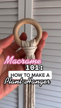 someone holding a wooden ring with rope on it and the words macrame 1018 how to make a plant hanger