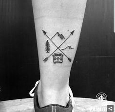 a person's foot with an arrow and car tattoo on the left side of their leg