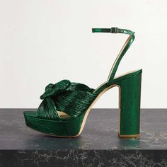 Step into style with these luxurious green platform sandals. Featuring an open toe, bow embellishment, and ankle strap for a secure fit, elevate your look with these chic block heel sandals. Color: Green Heel Type: Block heel Heel height: 4.72'' / 120 mm approx Product measurements were taken using size 8. Please note that measurements may vary by size. Toe: Open toe With platform Handcrafted US sizing. Fits true to size. Green Sandals With Heel Strap For Party, Green Chunky Platform Heels For Spring, Green Platform Sandals For Party, Green Ankle Strap Sandals For Party, Green High Heel Platform Sandals, Green Platform Heels With Ankle Strap, Green Chunky Platform Sandals With Round Toe, Green Synthetic Sandals With Chunky Platform, Chic Green Heels With Bow