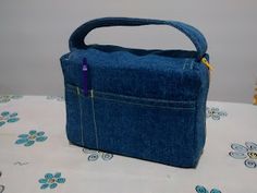 a denim bag with a pencil in the pocket on a tablecloth covered table cloth