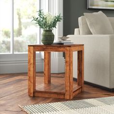 a living room scene with focus on the end table and sofa in the back ground