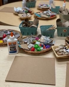 several baskets filled with craft supplies sitting on top of a table next to other items