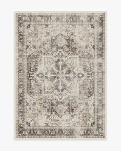 an area rug with grey, beige and white designs on the front in neutral tones