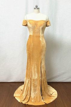 a gold dress on a mannequin headdress with an off the shoulder top