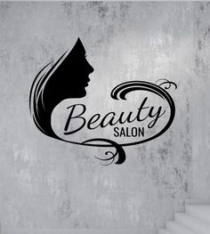 a woman's face with the words beauty salon in black on a gray background