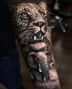 an animal tattoo on the arm of a man with yellow eyes and leopard's head