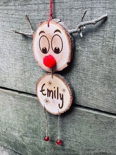 a wooden ornament with the word family painted on it's face and nose