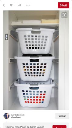 two white laundry baskets stacked on top of each other in an open cabinet with doors