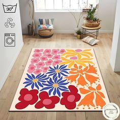 an area rug with colorful flowers on it in a living room next to a window