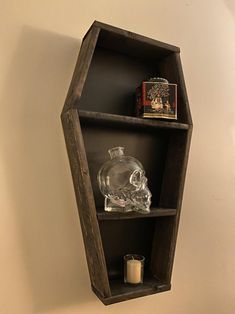 a wooden shelf with a glass skull on it