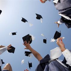 graduates throwing their caps in the air