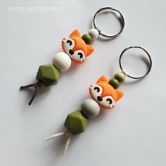 two key chains made to look like foxes