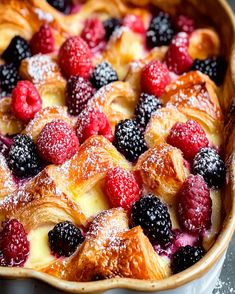 a baked pastry with berries and powdered sugar