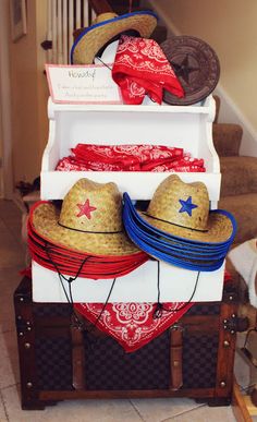 three hats are stacked on top of each other in an open trunk with red, white and blue decorations