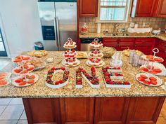 a kitchen counter topped with lots of desserts and fruit on top of the table