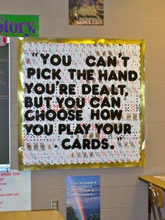 a bulletin board with writing on it in a school classroom setting that reads you can't pick the hand you're dead, but you can choose how you play your cards