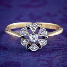 A pretty antique Edwardian diamond daisy cluster ring dotted with seven twinkling old mine-cut diamond petals (approx. 0.14ct total). The open-work gallery is edged with milgrain and fashioned in white gold, with an 18ct yellow gold back and band.  Diamonds are truly a stone of perfection, desired for their rarity, durability and exceptional sparkle that is second to none. Their superior qualities have made them the ultimate symbol of love across the ages with their strength and ceaseless fire r Edwardian Diamond Ring, Daisy Ring, Antique Gift, Love Symbols, Antique Jewellery, Antique Rings, Cluster Ring, Rarity, Wedding Rings Engagement