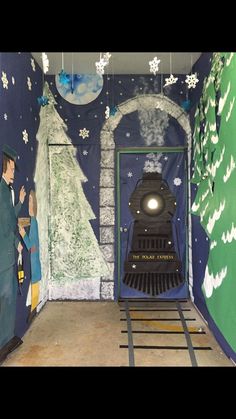 a train is coming out of a tunnel with christmas decorations on the walls and around it