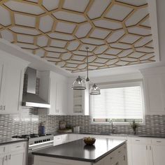 a large kitchen with white cabinets and black counter tops is decorated with gold geometric ceiling tiles